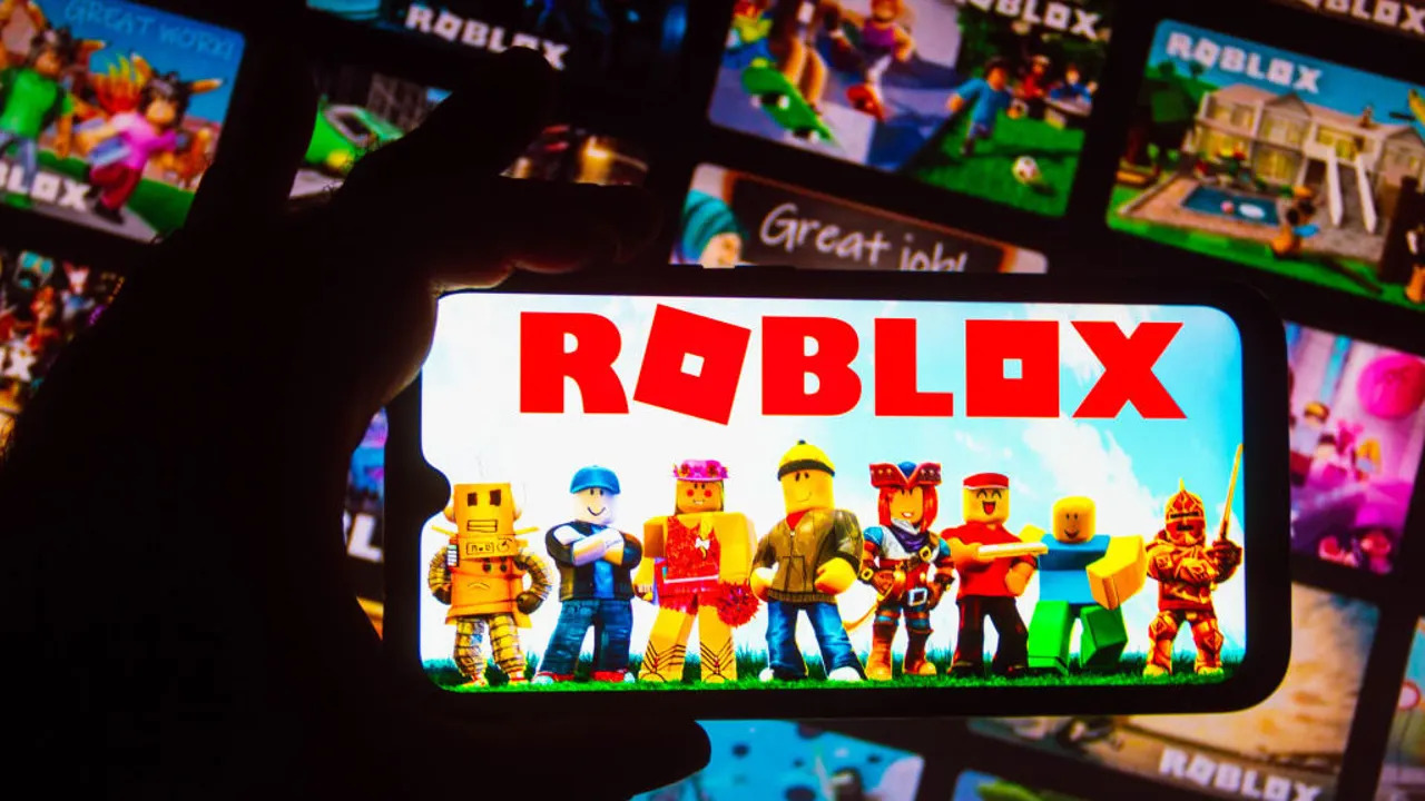 Children excitedly holding Robux cards and game subscription vouchers for Christmas